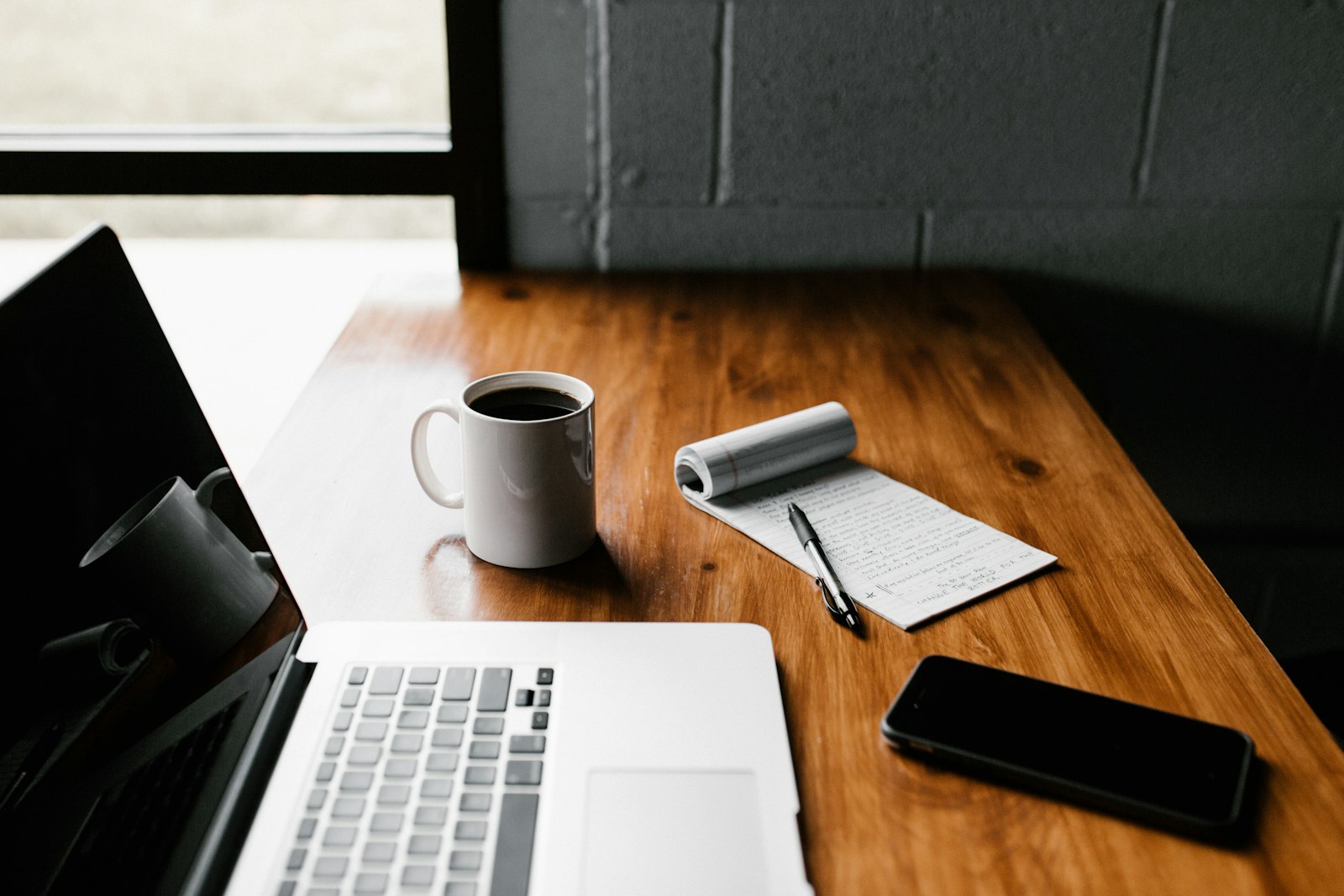 Professional software development workspace with laptop and code